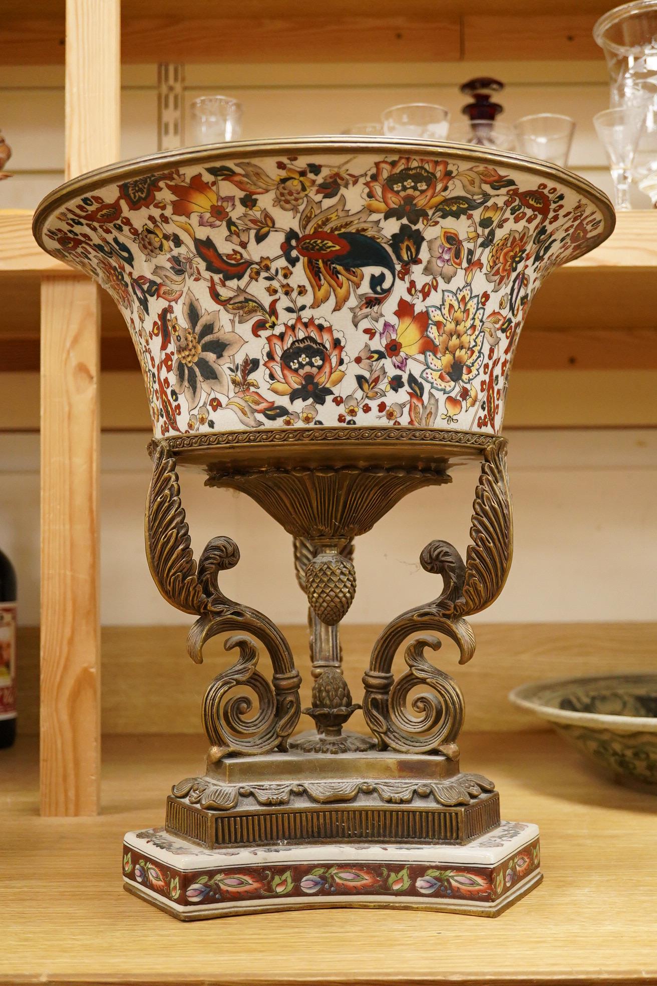 An early 20th century enamelled porcelain and ormolu mounted centrepiece with tripod scroll base, 41cm high